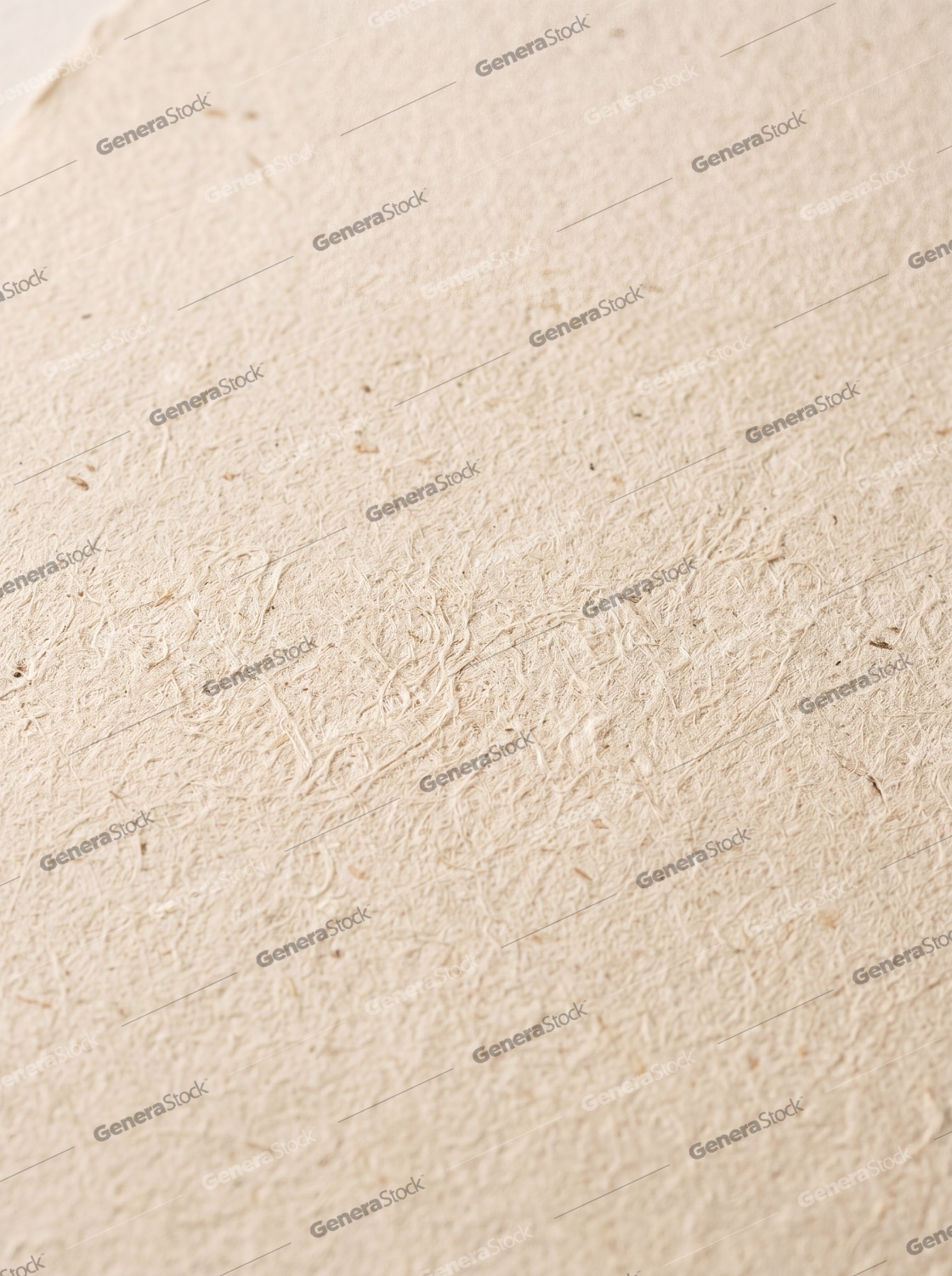 Close-up of beige handmade paper texture with visible organic fibers