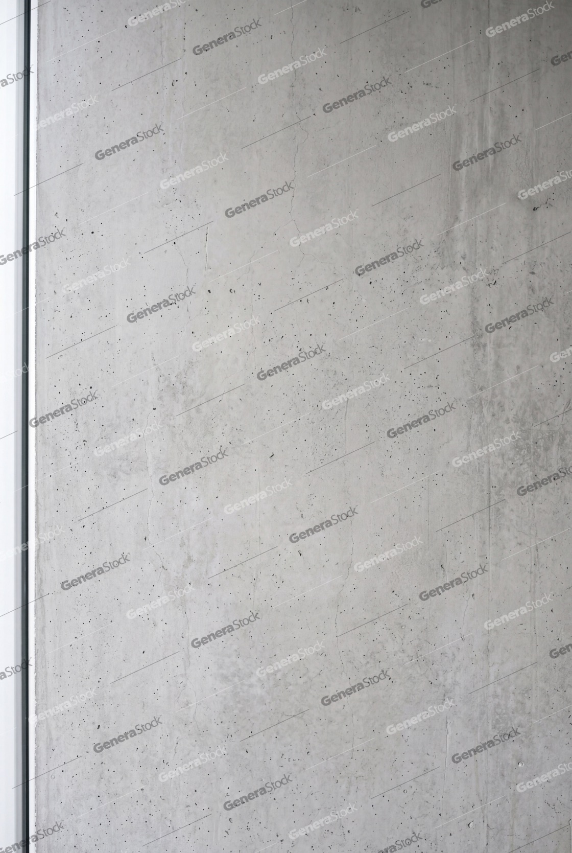Vertical shot of a raw gray concrete wall texture featuring a porous surface, subtle cracks, and industrial architectural details