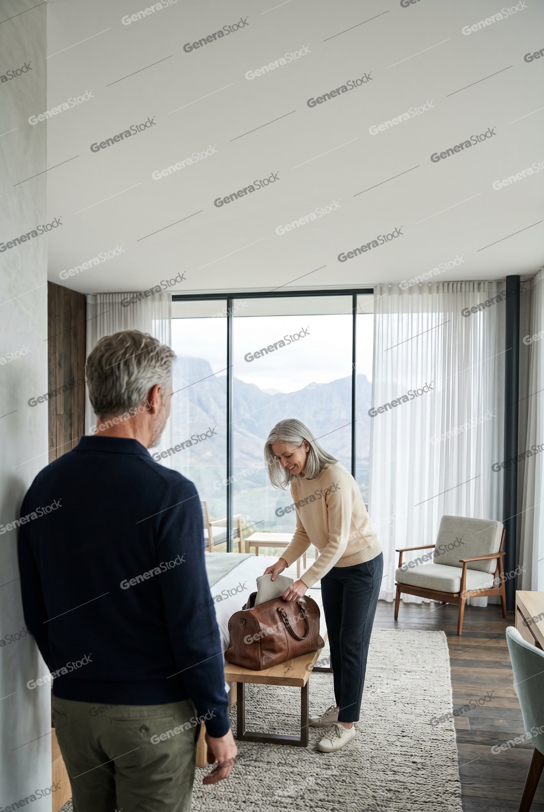 Senior Couple Packing Luggage in a Luxury Hotel Room with Mountain View