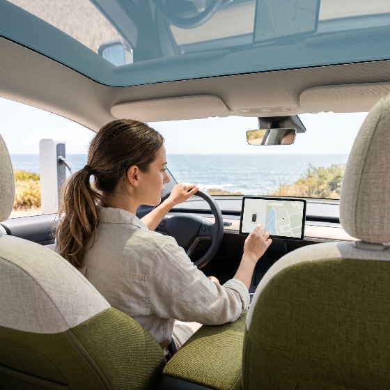 young, woman, using, navigation, system, touchscreen, inside, electric, car, parked, the, sea, near, charging, station, driving, dashboard, interior, coastal, ocean, travel, technology, sustainable, modern, panoramic, sunroof, gps, map, lifestyle, transportation, vehicle, automobile, driver, smart, eco-friendly, green, energy, future, road, trip, summer, vacation, digital, interface, connectivity, luxury, zero, emissions, clean, automotive, high, tech, innovative, mobility, autonomous, autopilot, scenic, nature, shore, vehicles