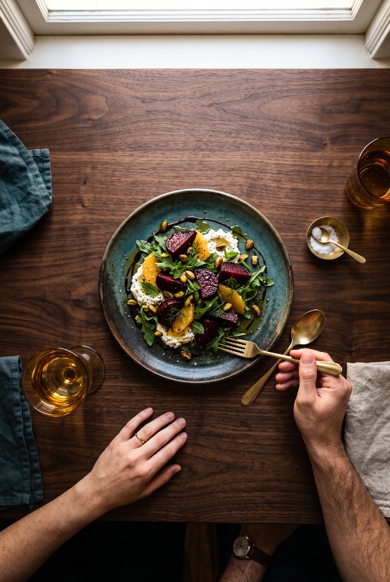 top, view, couple, eating, gourmet, roasted, beet, and, citrus, overhead, freshly, prepared, salad, featuring, orange, segments, creamy, cheese, fresh, arugula, pistachios, balsamic, drizzle, served, glazed, ceramic, plate, two, people, are, sitting, dark, wooden, table, with, wine, glasses, linen, napkins, salt, dish, one, person, using, golden, fork, enjoy, the, meal, warm, natural, sunlight, beetroot, ricotta, goat, pistachio, flat, lay, food, photography, healthy, dining, dinner, lunch, vegetarian, organic, hands, rustic, lifestyle, cuisine, nutrition, delicious, setting, glass, appetizer, seasonal, culinary, homemade, restaurant, olive, oil, green, drink