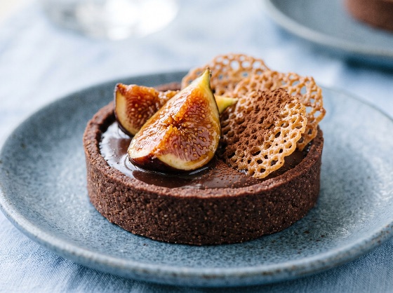 gourmet, chocolate, ganache, tartlet, garnished, with, fresh, juicy, fig, close-up, shot, served, rustic, blue, ceramic, plate, the, dessert, features, dark, cocoa, pastry, shell, filled, smooth, beautifully, topped, sliced, figs, and, delicate, golden, lace, tuile, biscuits, dusted, powder, set, light, linen, surface, bright, soft-focused, environment, tart, cake, crisp, sweet, bakery, delicious, food, photography, slice, fruit, homemade, recipe, crust, luxury, close, treat, pie, dish, meal, confectionery, baked, baking, restaurant, elegance, table, napkin, ripe, organic, topping, cookie, tasty, snack, drink