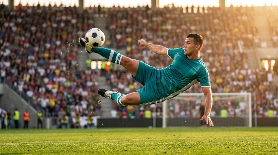 professional, soccer, player, teal, uniform, performing, spectacular, bicycle, kick, during, match, crowded, stadium, sunset, football, athlete, sport, action, overhead, goal, pitch, field, competition, skill, athletic, jump, ball, arena, crowd, spectators, golden, hour, sunlight, dynamic, movement, scoring, kit, male, man, game, outdoor, grass, sports, fitness