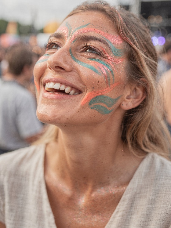 happy, young, woman, with, colorful, glitter, face, paint, and, artistic, close-up, joyful, vibrant, makeup, she, smiles, looks, crowded, outdoor, summer, music, festival, smiling, joy, celebration, youth, lifestyle, party, event, portrait, beauty, cheerful, looking, fun, glittery, sparkle, people, crowd, leisure, happiness, adult, caucasian, freckles, natural, skin, teeth, smile, laughing, holiday, vacation, weekend, social, gathering, entertainment, concert, rave, carnival, bohemian, hippie, style