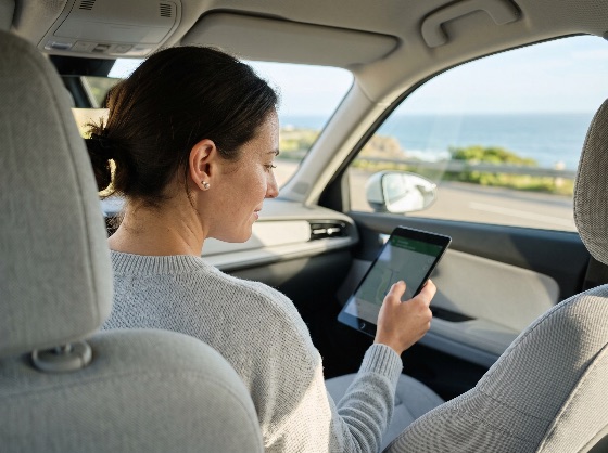 young, woman, using, digital, tablet, for, navigation, during, scenic, coastal, road, trip, car, travel, passenger, interior, vehicle, technology, map, gps, ocean, sea, vacation, summer, lifestyle, screen, holding, looking, journey, adventure, transportation, modern, female, caucasian, view, window, seat, planning, route, mobile, device, wireless, internet, connectivity, leisure, tourism, holiday