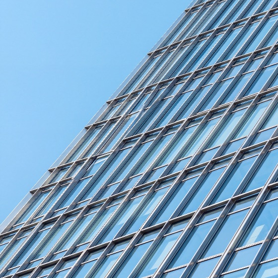 modern, glass, skyscraper, facade, with, sleek, architectural, design, featuring, blue, windows, and, metallic, frame, set, against, clear, sky, minimalist, urban, business, district, architecture, building, office, window, exterior, city, construction, steel, reflection, corporate, high-rise, structure, geometric, pattern, perspective, contemporary, real, estate, finance, commercial, tower, detail, abstract, background, bright, tall, downtown, development, engineering, futuristic, wall, low, angle, vertical, industrial, metropolis, buildings