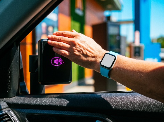 person, using, smartwatch, for, contactless, payment, drive-thru, window, nfc, technology, car, terminal, fast, food, wireless, digital, wallet, convenience, modern, lifestyle, hand, reaching, service, finance, transaction, cashless, tap, pay, wearable, consumerism, purchase, commerce, retail, automotive