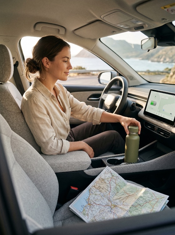 young, woman, sitting, the, driver, seat, modern, car, during, coastal, road, trip, reaching, for, reusable, water, bottle, travel, map, navigation, lifestyle, interior, vehicle, adventure, vacation, ocean, mountain, golden, hour, sunset, linen, shirt, sustainable, hydration, dashboard, steering, wheel, cup, holder, exploration, tourism, transport, automobile, passenger, technology, gps, screen, display, nature, scenic, journey, solo, female, adult, caucasian, healthy, serene, peaceful, driving, leisure, transportation, vehicles
