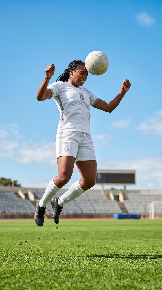 athletic, african, american, female, soccer, player, jumping, high, head, ball, green, field, stadium, under, clear, blue, sky, football, athlete, heading, jump, sport, action, woman, professional, match, training, competition, grass, outdoor, exercise, fitness, black, uniform, jersey, cleats, pitch, active, lifestyle, motivation, skill, power, strength, determination, game, team, sportswoman, the, mid-air, sports, photography, background
