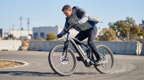 active, man, riding, modern, electric, mountain, bike, paved, road, leaning, into, sharp, turn, during, sunny, day, e-bike, cycling, bicycle, lifestyle, transportation, speed, turning, asphalt, outdoor, fitness, technology, battery, motor, sport, exercise, urban, leisure, eco-friendly, mobility, commuter, mtb, pedelec, action, manoeuvring, sustainable, green, energy, adventure, recreation, male, person, one, vehicles
