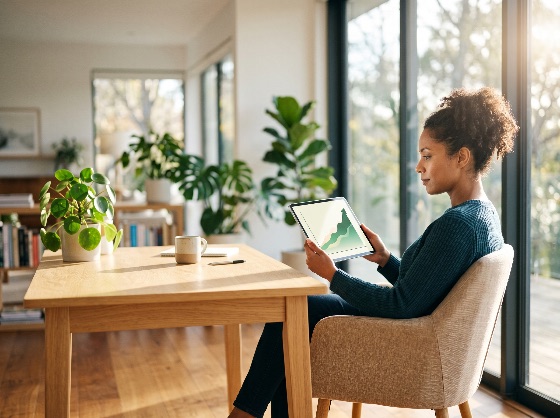 professional, woman, analyzes, financial, growth, charts, digital, reviews, data, tablet, bright, home, office, she, sits, wooden, table, surrounded, lush, houseplants, natural, light, streams, through, large, windows, highlighting, her, focused, expression, manages, business, investments, from, finance, chart, graph, working, remote, work, nomad, entrepreneur, black, african, american, curly, hair, plants, indoor, monstera, pilea, houseplant, sunlight, modern, interior, desk, technology, analysis, investment, success, productivity, freelance, lifestyle, casual, morning, coffee, mug, residential, window, glass, door, focus, planning, marketing, strategy, corporate, startup, e-learning