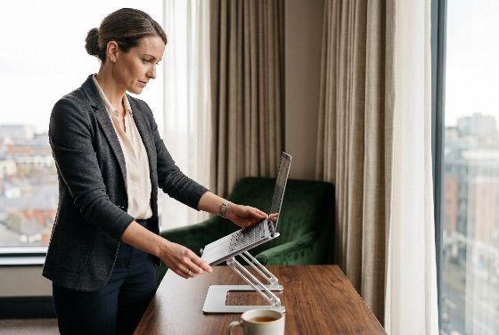 professional, businesswoman, adjusting, laptop, ergonomic, stand, modern, office, with, city, view, working, business, desk, technology, corporate, woman, productivity, remote, work, home, computer, workplace, lifestyle, career, executive, success, focus, elegant, interior, furniture, workspace, digital, internet, communication, job, employee, management, leadership, health, posture, wellness, comfort, smart, casual, blazer, urban, window, light, daylight, finance