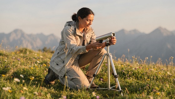female, scientist, researcher, adjusting, precision, measuring, tactical, outdoor, clothing, kneels, vibrant, alpine, meadow, she, carefully, adjusts, scientific, monitoring, device, sensor, mounted, tripod, the, scene, set, against, backdrop, hazy, mountain, peaks, during, golden, hour, highlighting, environmental, field, research, and, data, collection, remote, natural, setting, technology, nature, environment, work, science, wildflowers, equipment, ecology, biology, geologist, outdoors, hiking, adventure, professional, sunset, landscape, wilderness, measurement, instrument, adult, woman, jacket, pants, boots, kneeling, working, climate, change, conservation, sustainability, high, altitude, exploration, survey, geology, landscapes