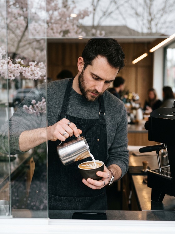 professional, barista, pouring, steamed, milk, create, latte, art, modern, cafe, setting, with, spring, cherry, blossoms, coffee, espresso, man, shop, drink, beverage, apron, blossom, lifestyle, artisanal, craft, hospitality, service, cappuccino, morning, breakfast, skill, preparation, culture, restaurant, hot, caffeine, small, business, worker, male, urban, cozy, food