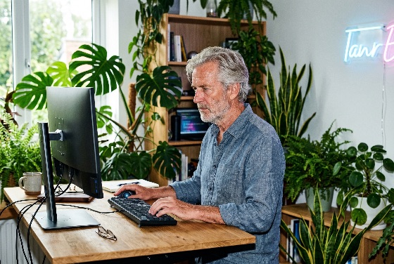senior, man, working, computer, lush, green, home, office, with, indoor, plants, biophilic, design, remote, work, technology, professional, grey, hair, beard, lifestyle, monstera, fern, snake, plant, desk, wooden, keyboard, trackball, focused, developer, programmer, freelancer, retirement, age, active, interior, nature, workspace, productivity, male, caucasian, adult, mature, business, entrepreneur, digital, nomad, modern, cozy, hobby, gardening, environment, sustainability, health, wellness, finance