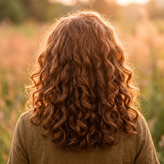 back, view, woman, with, long, voluminous, curly, reddish-brown, hair, standing, field, during, golden, hour, sunset, red, auburn, care, hairstyle, nature, ginger, volume, texture, sunlight, backlit, outdoor, beauty, feminine, lifestyle, warm, light, glowing, meadow, serene, peaceful, health, natural, ringlets, waves, fashion, style, autumn, summer, evening, person