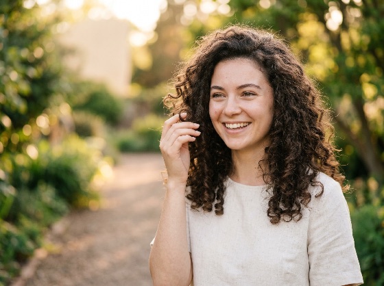 happy, young, woman, with, long, curly, hair, smiling, sunlit, garden, during, golden, hour, portrait, nature, sunset, lifestyle, beautiful, female, brunette, outdoor, natural, joy, laughter, care, skincare, linen, shirt, summer, spring, park, bokeh, sunlight, warmth, cheerful, positive, person, caucasian, attractive, healthy, wellness, serenity, peaceful, casual, candid, people