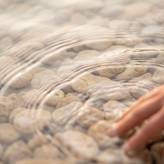 close-up, shot, person, hand, gently, touching, the, surface, clear, shallow, water, creating, soft, ripples, over, smooth, white, pebbles, bottom, during, warm, golden, sunset, stones, transparent, nature, touch, sensory, peaceful, serene, calm, river, lake, beach, outdoor, wellness, relaxation, spa, purity, clean, liquid, movement, motion, hour, light, reflection, texture, background, abstract, human, interaction, environment, ecology, conservation, fresh, cool, summer, vacation, zen, mindfulness, landscapes