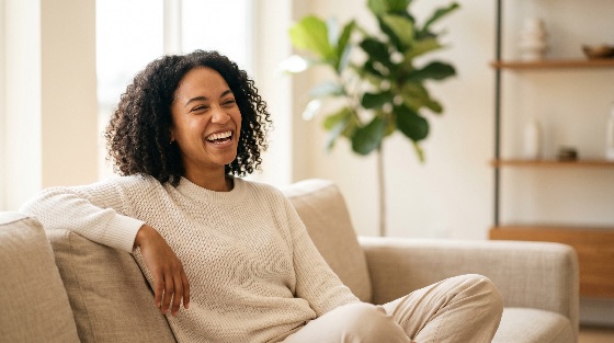 joyful, young, african, american, woman, with, curly, hair, laughing, while, relaxing, comfortable, sofa, bright, modern, living, room, happy, black, smiling, home, lifestyle, joy, cheerful, interior, positive, leisure, apartment, casual, sweater, indoor, wellness, mental, health, natural, light, house, domestic, one, person, people