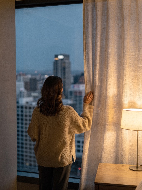 woman, cozy, sweater, opens, the, curtain, admire, city, rear, view, young, standing, modern, high-rise, apartment, hotel, room, during, twilight, she, pulling, back, linen, look, out, large, window, illuminated, cityscape, and, skyscrapers, warm, interior, light, from, table, lamp, contrasts, with, cool, evening, ambient, outside, creating, serene, atmosphere, skyline, looking, dusk, urban, indoor, lifestyle, skyscraper, relaxation, peaceful, home, travel, open, contemplative, architecture, building, night, accommodation, female, blue, hour, downtown, comfort, calm, solitary, luxury, staycation, glass, buildings