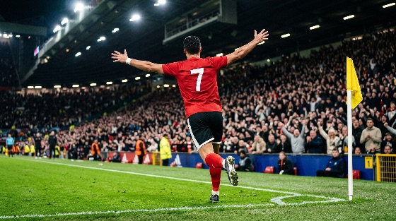 professional, soccer, player, red, number, seven, jersey, celebrating, goal, crowded, stadium, night, football, celebration, athlete, match, sport, crowd, fans, cheering, floodlights, pitch, grass, corner, flag, victory, win, success, emotion, action, competition, arena, spectator, team, league, championship, tournament, outdoor, male, man, back, view, scoring, triumph, energy, sports, fitness