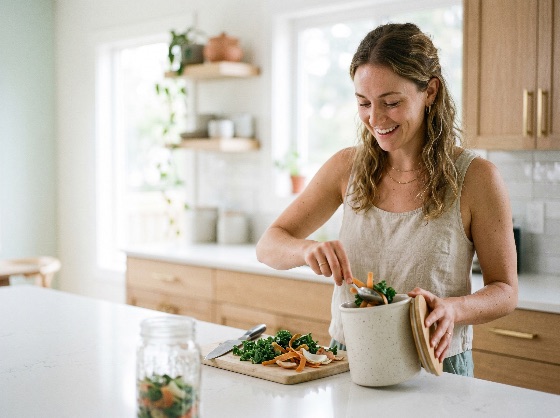 happy, young, woman, putting, vegetable, scraps, into, ceramic, compost, bin, bright, modern, kitchen, promoting, sustainable, living, and, zero, waste, composting, eco-friendly, recycling, organic, green, sustainability, lifestyle, healthy, environment, domestic, life, home, food, conscious, consumer, smiling, interior, natural, management, peels, kale, cutting, board, cooking, eco-conscious, environmentalism, indoor, plants, morning, airy, wellness, responsible, conservation, earth-friendly, bio-waste, fertilizer, soil, gardening, household, people