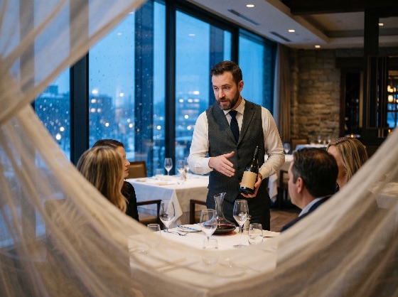 professional, sommelier, presenting, bottle, wine, guests, luxury, restaurant, fine, dining, waiter, hospitality, service, dinner, evening, upscale, lifestyle, group, friends, elegance, alcohol, beverage, glass, decanter, formal, vest, presentation, expert, tasting, food, drink, interior, city, view, night, atmosphere, catering, customer, male, table, tablecloth, celebration, gourmet, bistro, industry, tourism, leisure, socializing