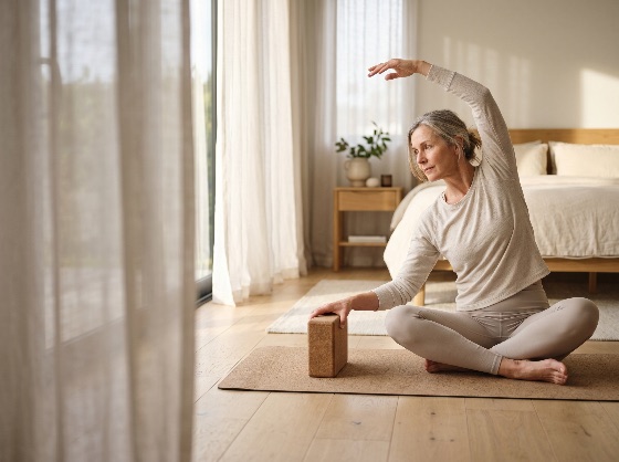 mature, woman, practicing, yoga, side, stretch, with, cork, block, bright, minimalist, bedroom, senior, exercise, stretching, home, workout, wellness, fitness, healthy, lifestyle, active, aging, mindfulness, meditation, interior, mat, flexibility, calm, peaceful, serene, middle-aged, grey, hair, morning, routine, self-care, natural, light, leisure, health, wellbeing, lady, person, female, indoor, domestic, relaxation, pilates, training, sports